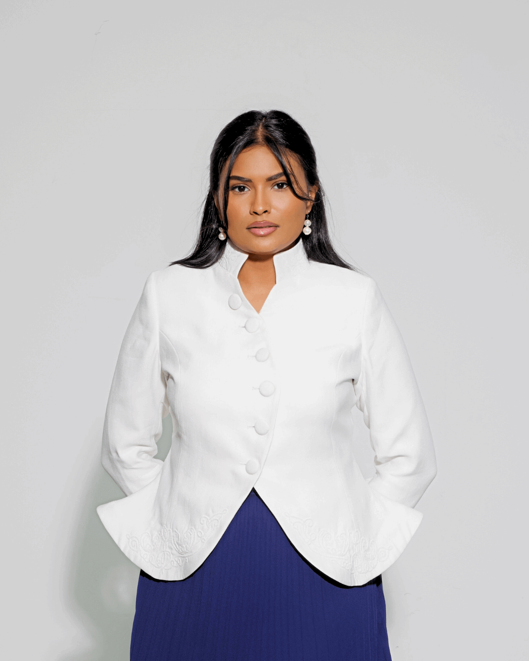 The Noor worn open, front view showing the stand collar, curved button line and shaped waist