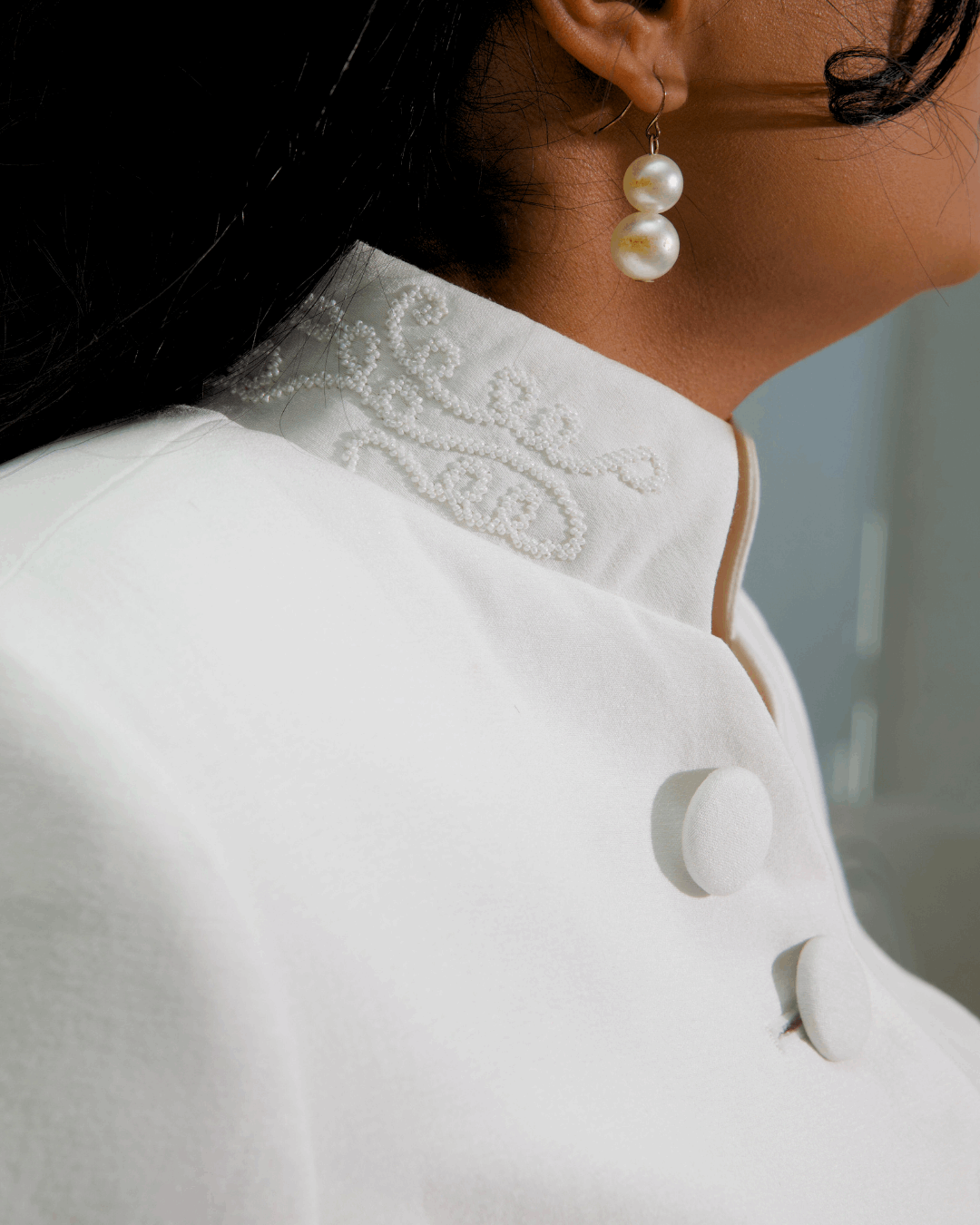 The Noor's stand collar with hand-worked white seed-bead scrollwork