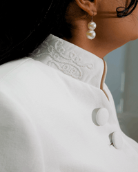 The Noor's stand collar with hand-worked white seed-bead scrollwork