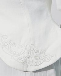 Detail of the Noor's boned front hem panel embroidered with baroque white bead scrollwork